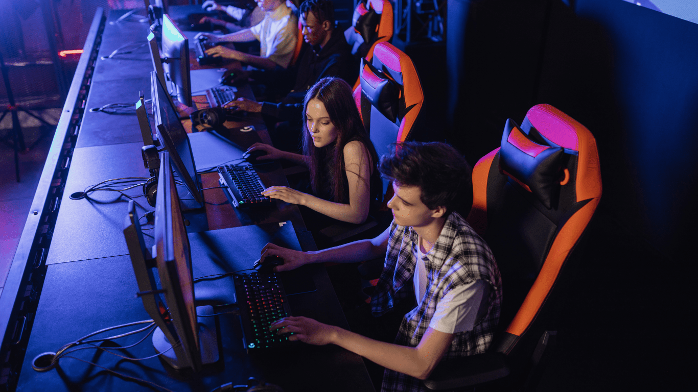 a group of people playing video games in a dark room