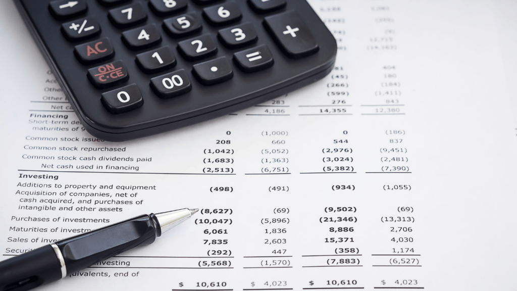 calculator and a pen on financial documents