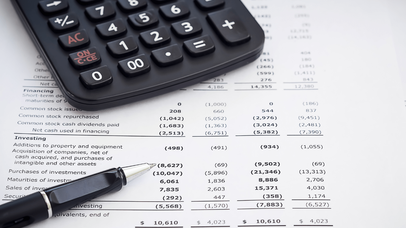 calculator and a pen on financial documents