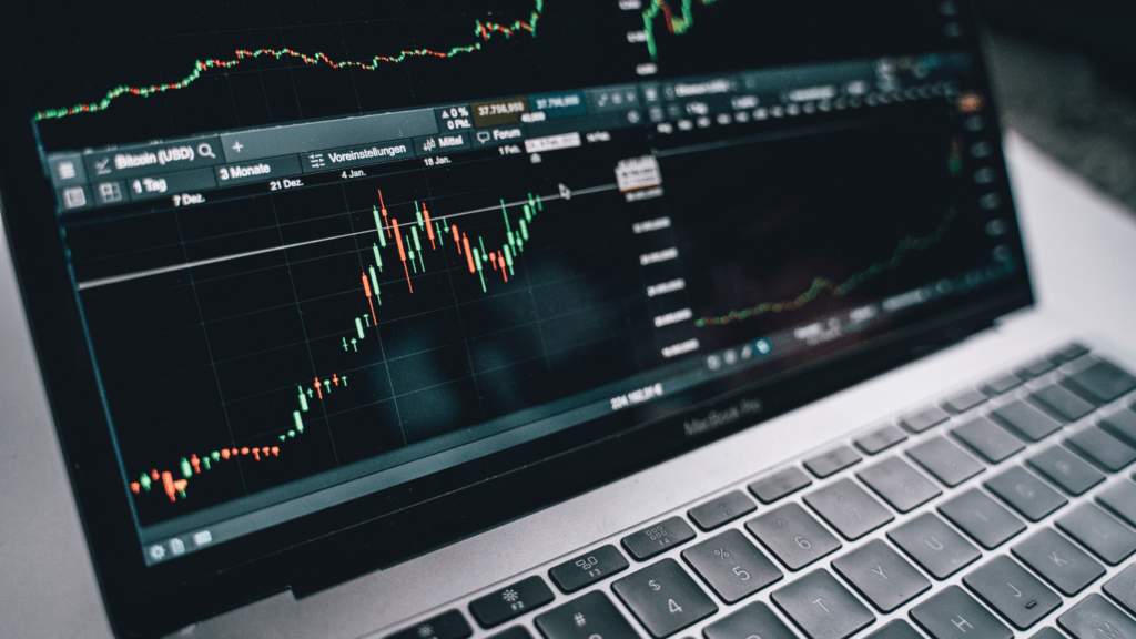 the stock market is shown on a large screen