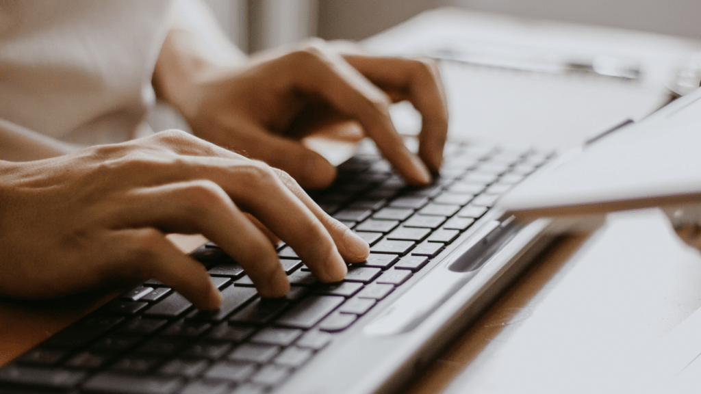 two people working on their laptops in front of each other