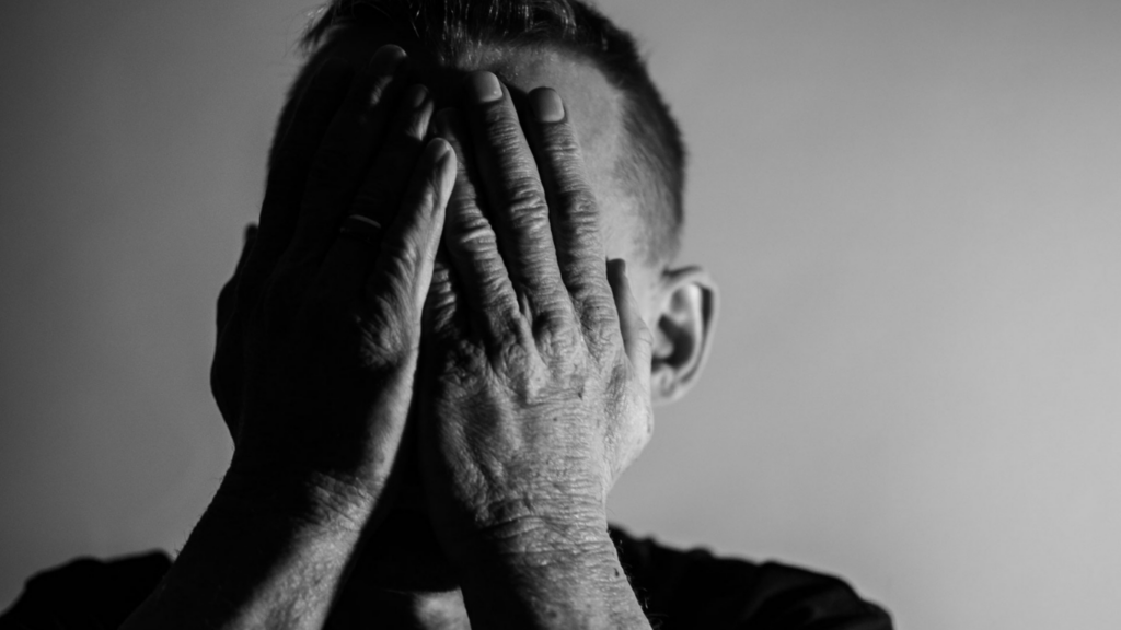 a person covering their face