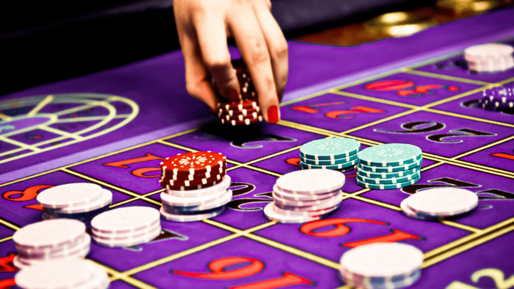 a person holding a casino chips