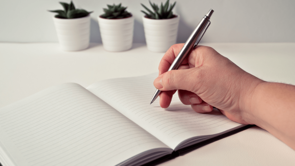 a person writing in a book
