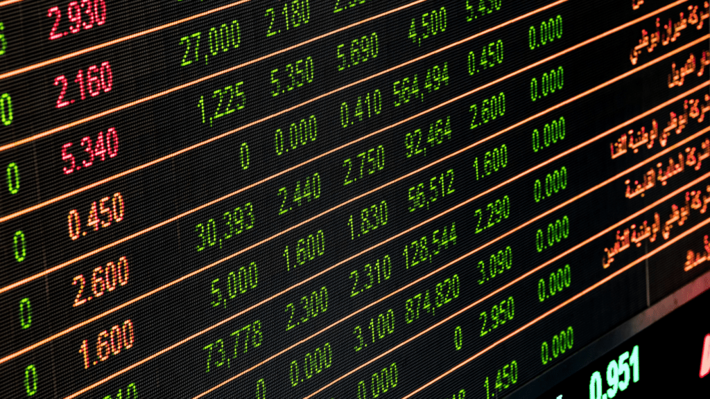 the stock market is shown on a large screen